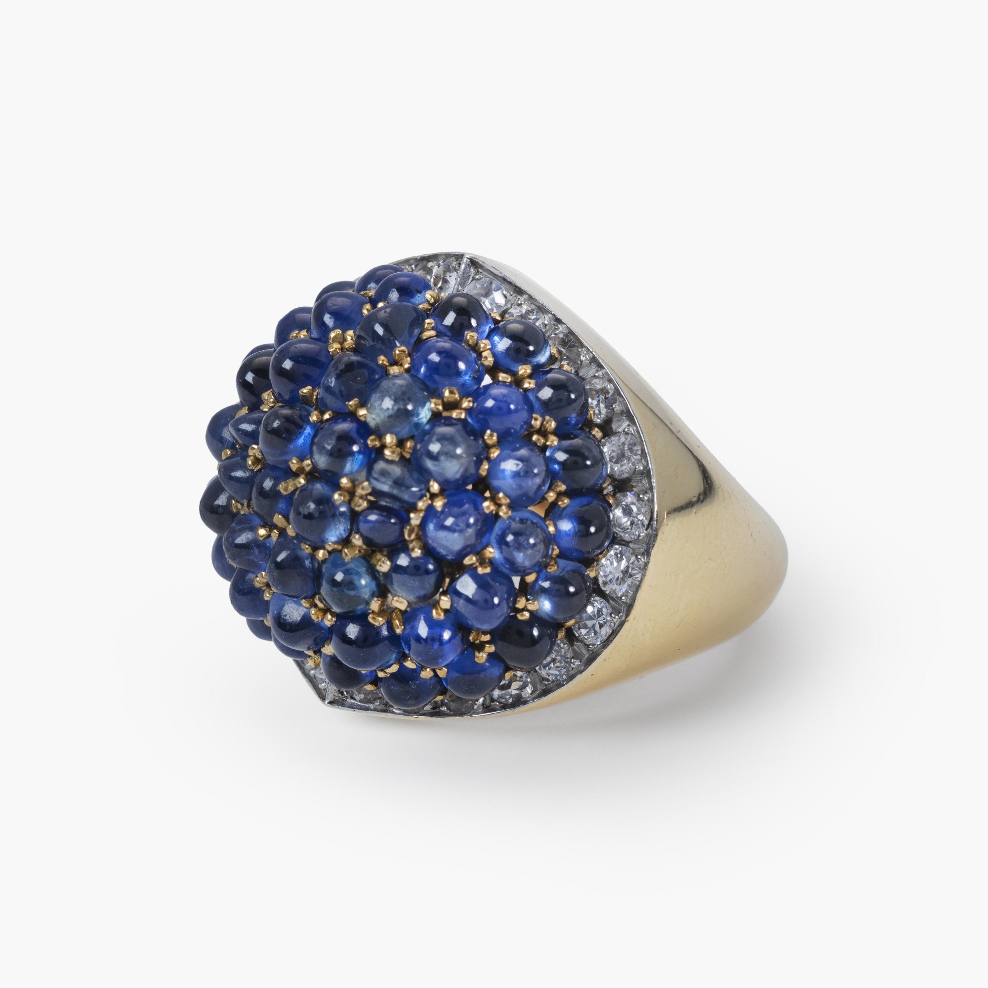 An eighteen carat yellow gold and platinum ring, pavé set with sapphires, surrounded by brilliant-cut diamonds. Signed Van Cleef & Arpels and numbered.