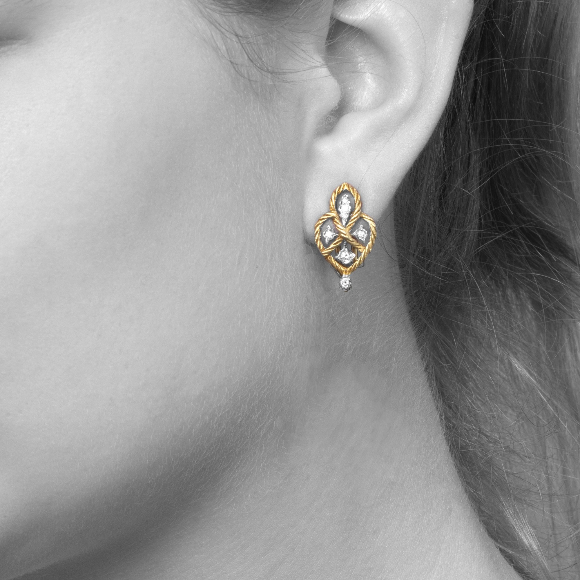 A pair of eighteen-carat yellow gold clip-earrings with detachable pendants, model ‘Étoilée’, set with diamonds. Signed Gianmaria Buccellati, Italy.