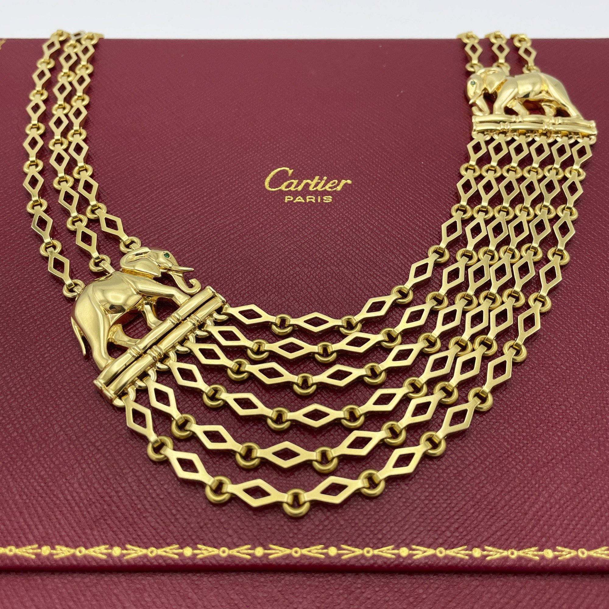An eighteen carat yellow gold “Djigar” necklace, with two stylized elephants. Signed Cartier, Paris, circa 1995. Numbered and in original fold-over case.