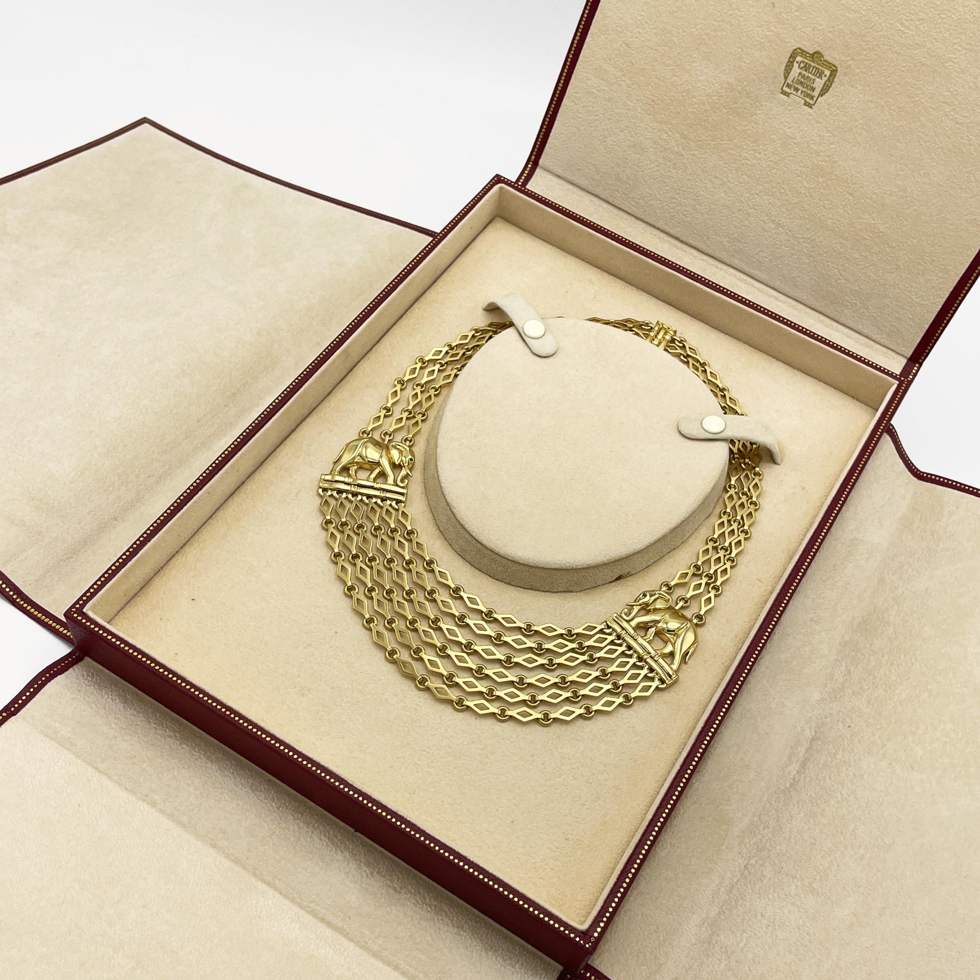 An eighteen carat yellow gold “Djigar” necklace, with two stylized elephants. Signed Cartier, Paris, circa 1995. Numbered and in original fold-over case.