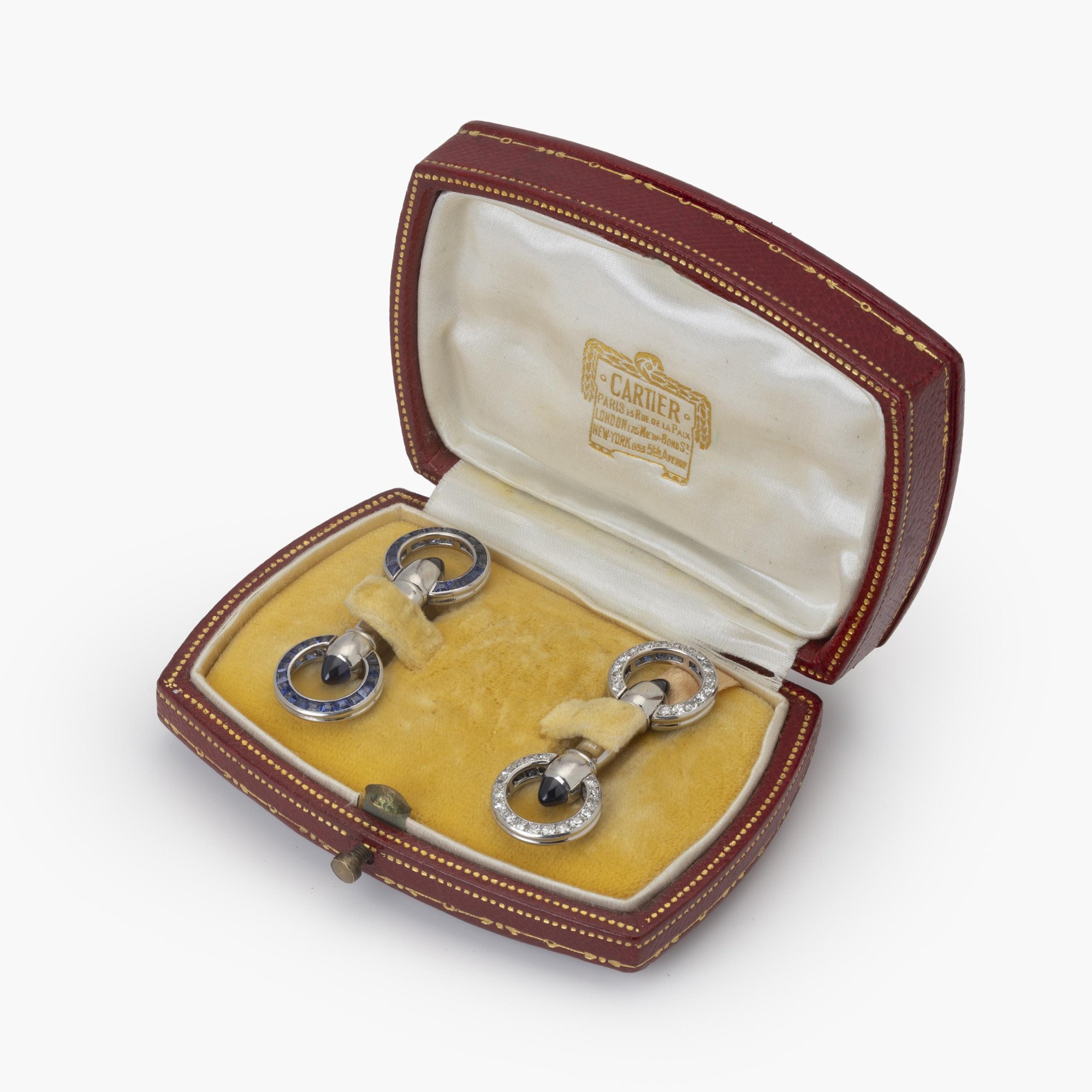 A pair of platinum Art Deco cufflinks, set with sapphires and diamonds. Signed Cartier Paris-made in France and numbered. Made ca 1925. In original case.