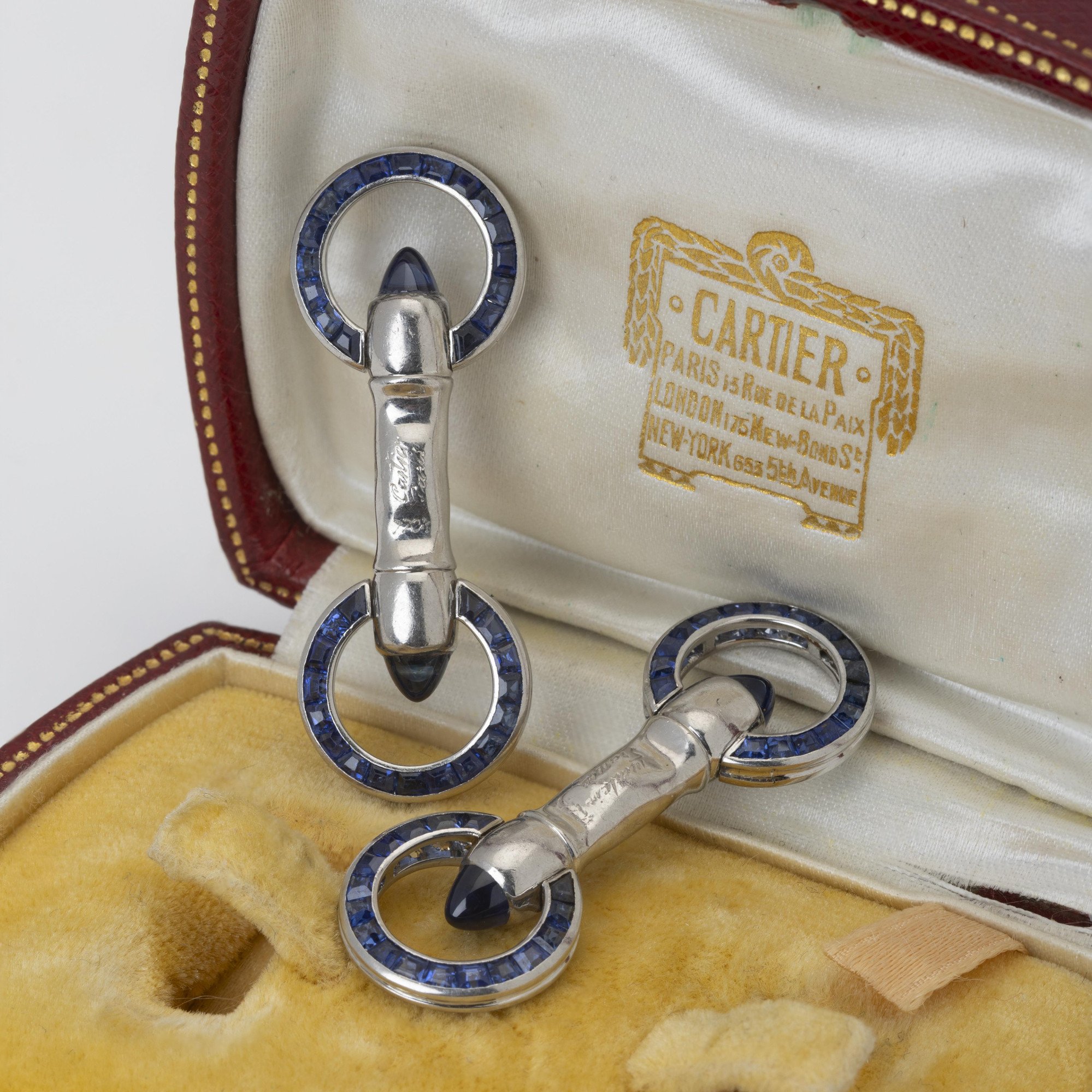 A pair of platinum Art Deco cufflinks, set with sapphires and diamonds. Signed Cartier Paris-made in France and numbered. Made ca 1925. In original case.