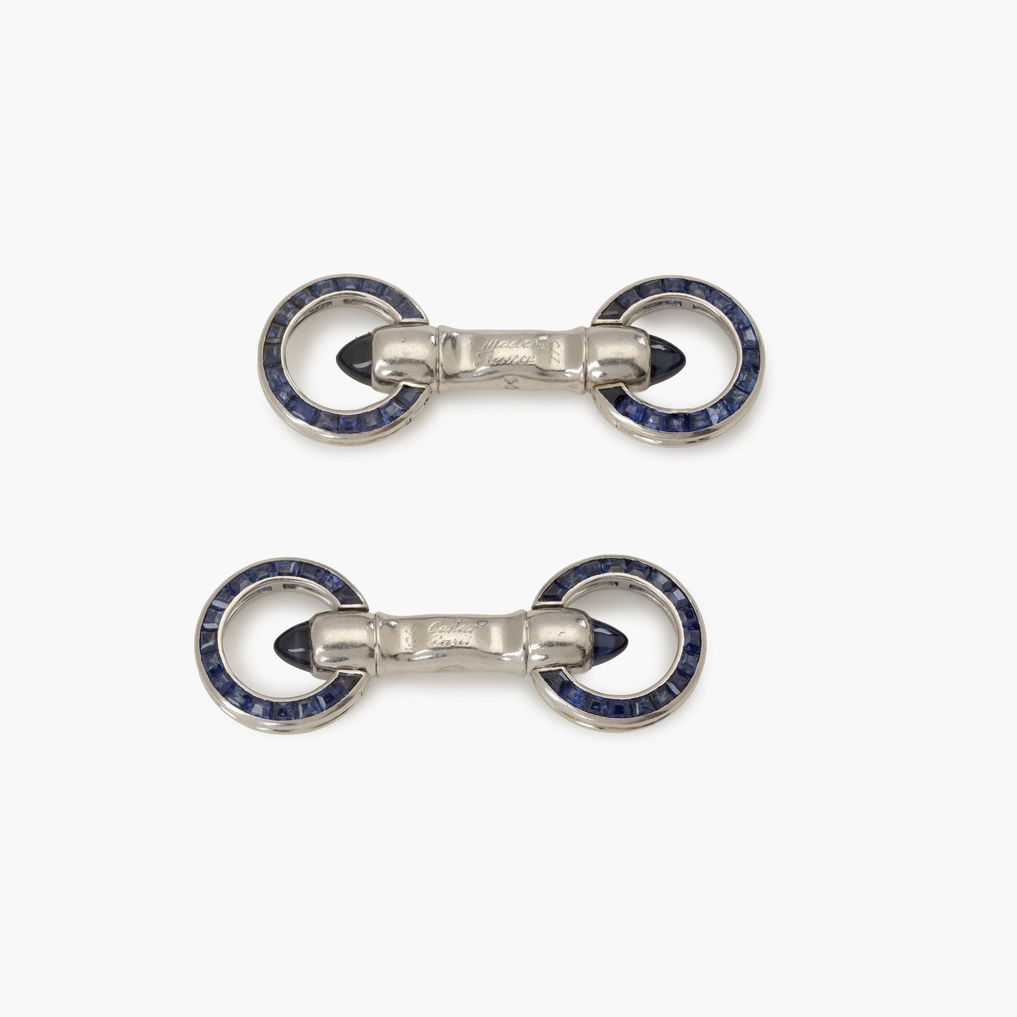 A pair of platinum Art Deco cufflinks, set with sapphires and diamonds. Signed Cartier Paris-made in France and numbered. Made ca 1925. In original case.