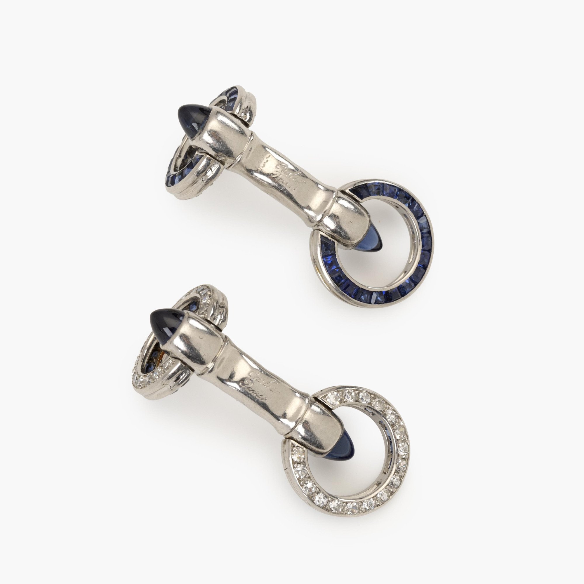 A pair of platinum Art Deco cufflinks, set with sapphires and diamonds. Signed Cartier Paris-made in France and numbered. Made ca 1925. In original case.