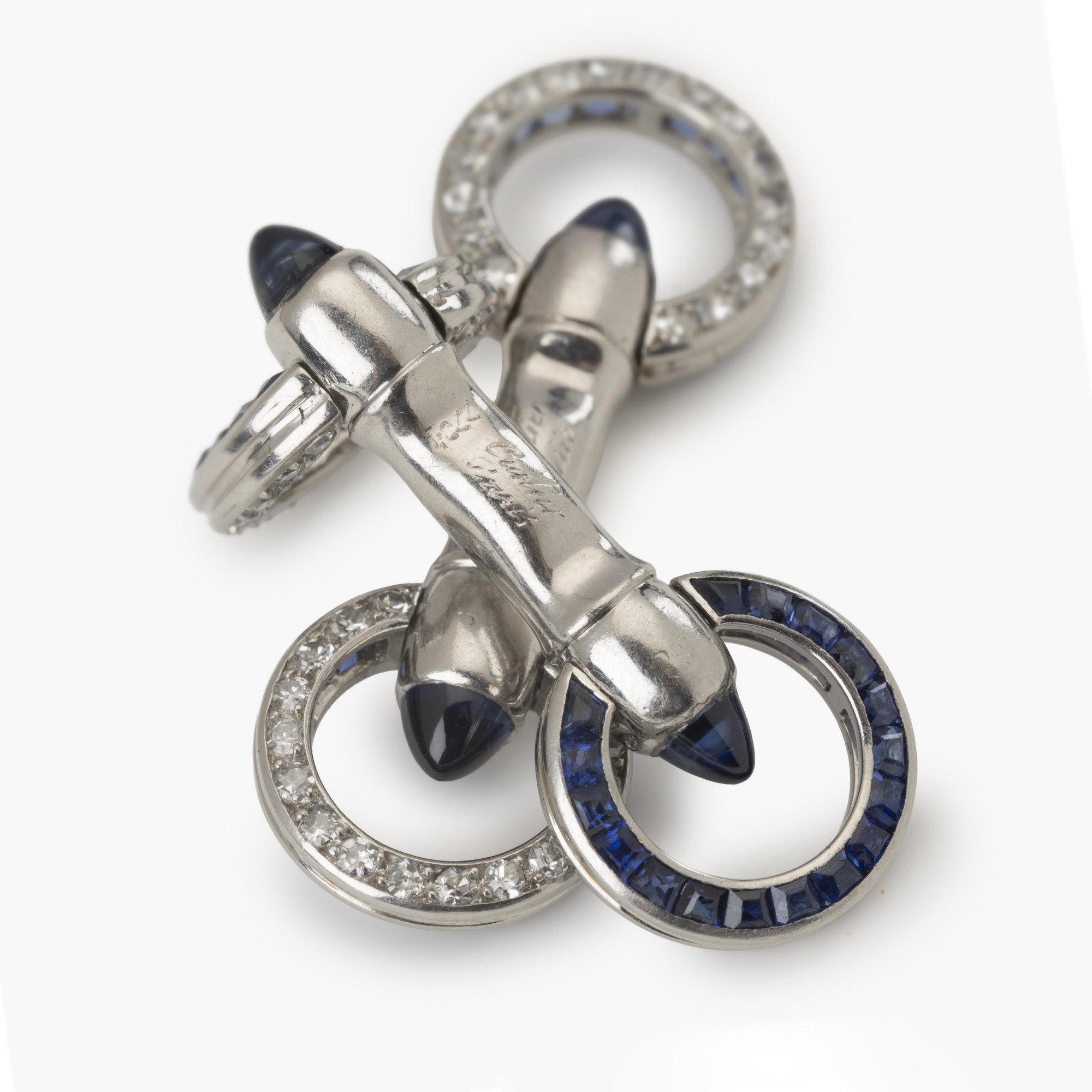 A pair of platinum Art Deco cufflinks, set with sapphires and diamonds. Signed Cartier Paris-made in France and numbered. Made ca 1925. In original case.
