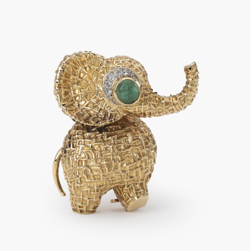An eighteen carat yellow gold brooch designed as an elephant, the eye is an emerald with diamonds. Signed Van Cleef & Arpels, made in Paris, circa 1970.