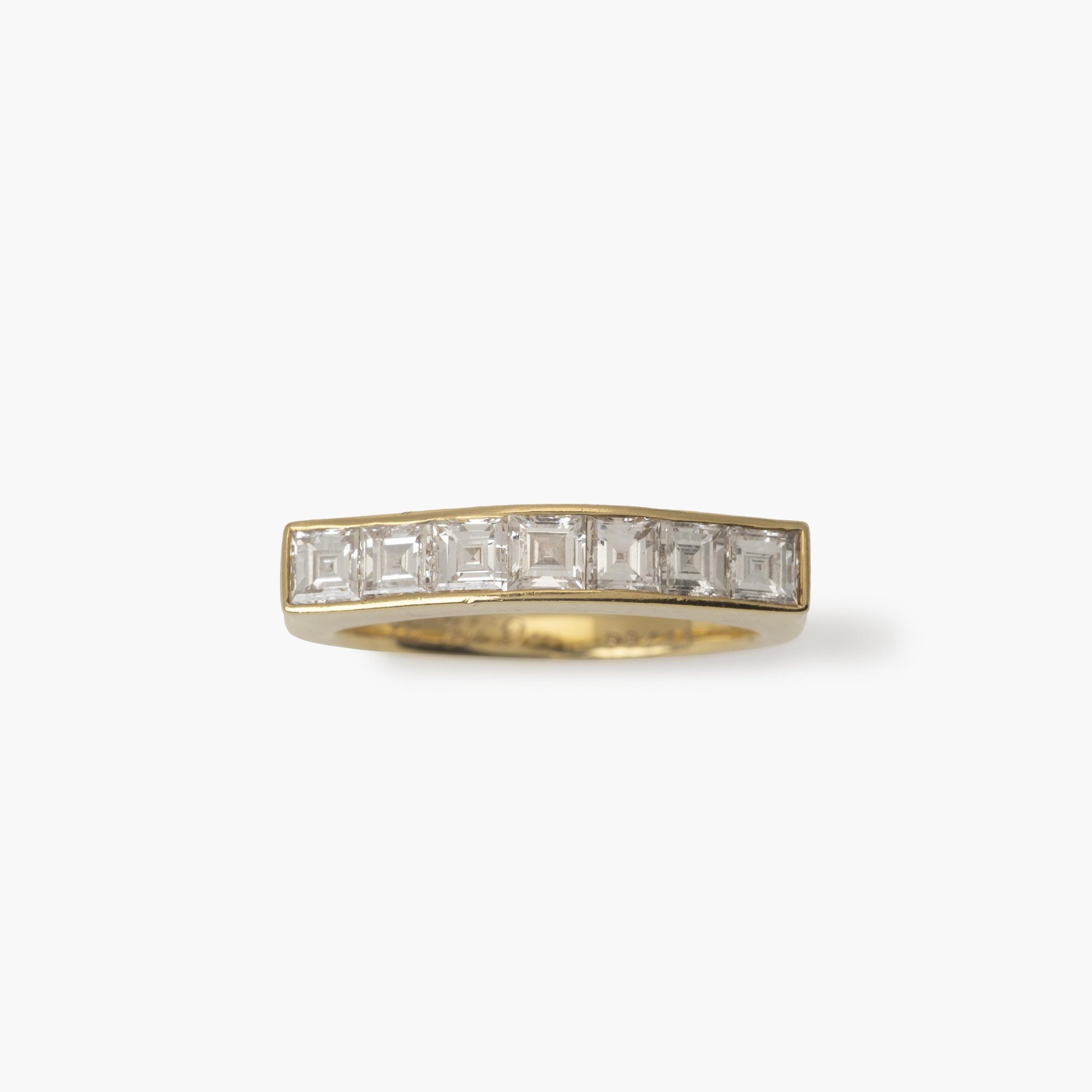 An eighteen carat yellow gold ring with a ondulating top, set with square-cut diamonds in a rail setting. Signed Cartier Paris and numbered. Made ca 1975.