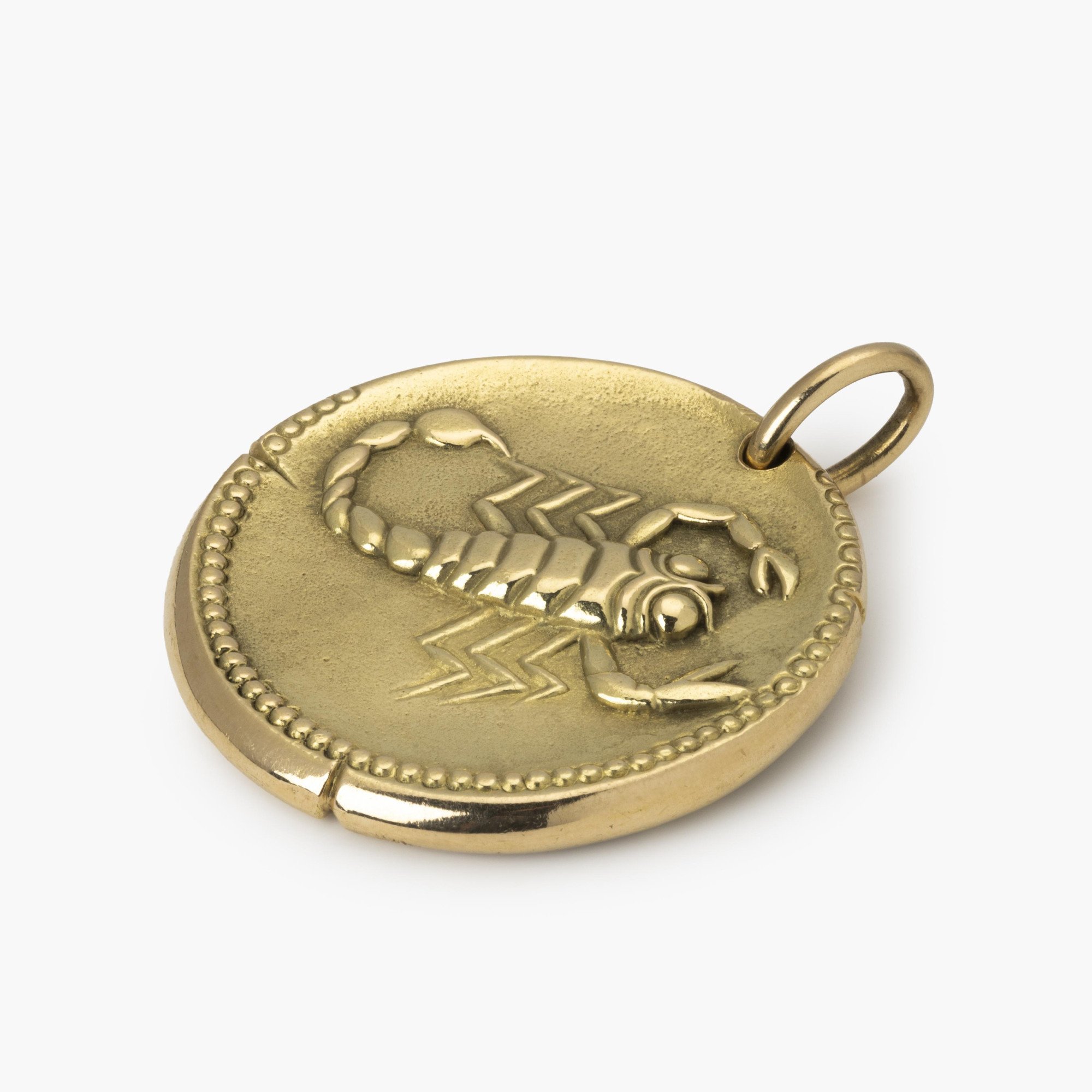 An eighteen carat yellow gold pendant with the zodiac sign scorpio. Signed Van Cleef & Arpels, Paris, ca 1970. With maker’s mark of Georges Lenfant, Paris.