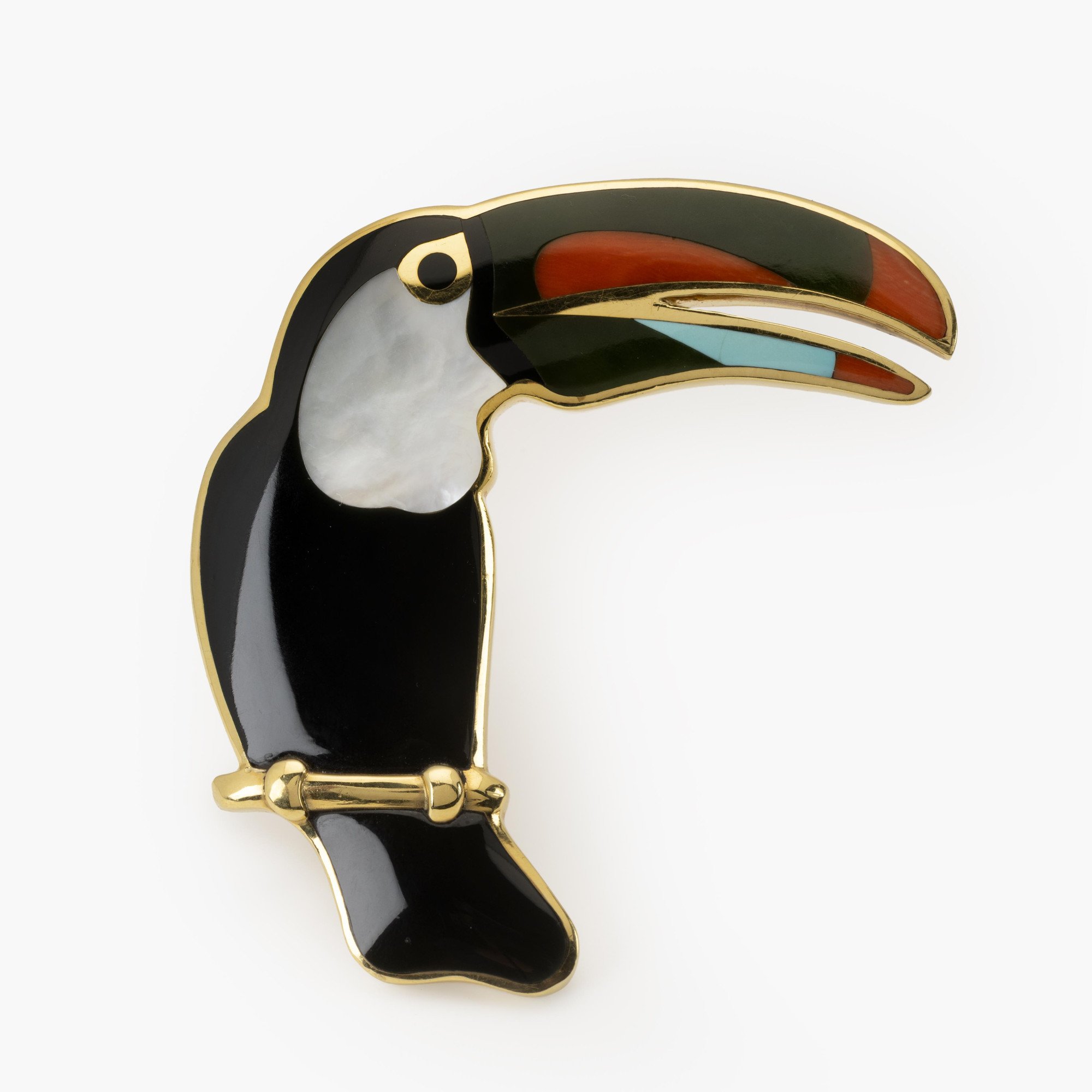 An eighteen karat yellow gold broche, designed as a toucan, inlayed with black jade, mother-of-pearl, coral, nefrite and turquoise. Tiffany & Co., ca 1980.