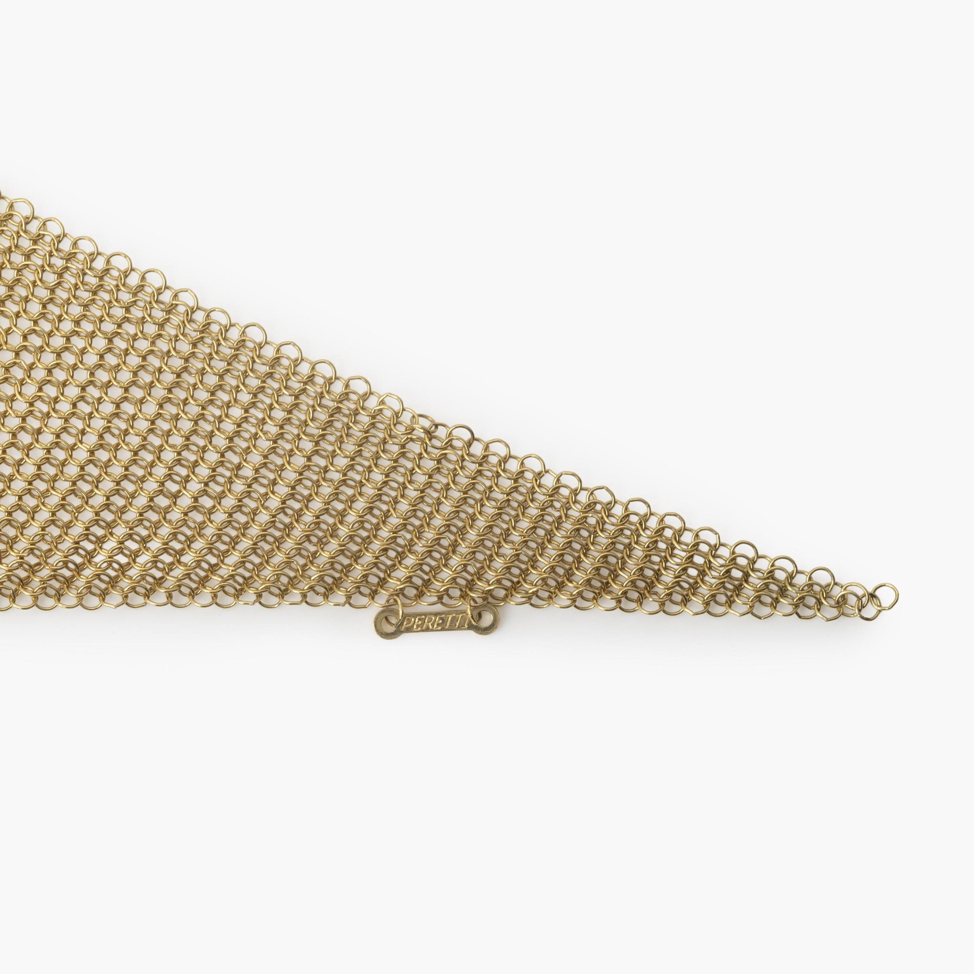 An eighteen carat yellow gold necklace designed as a scarf, signed Elsa Peretti for Tiffany & Co., made in the USA, ca 1980. With original pouch.