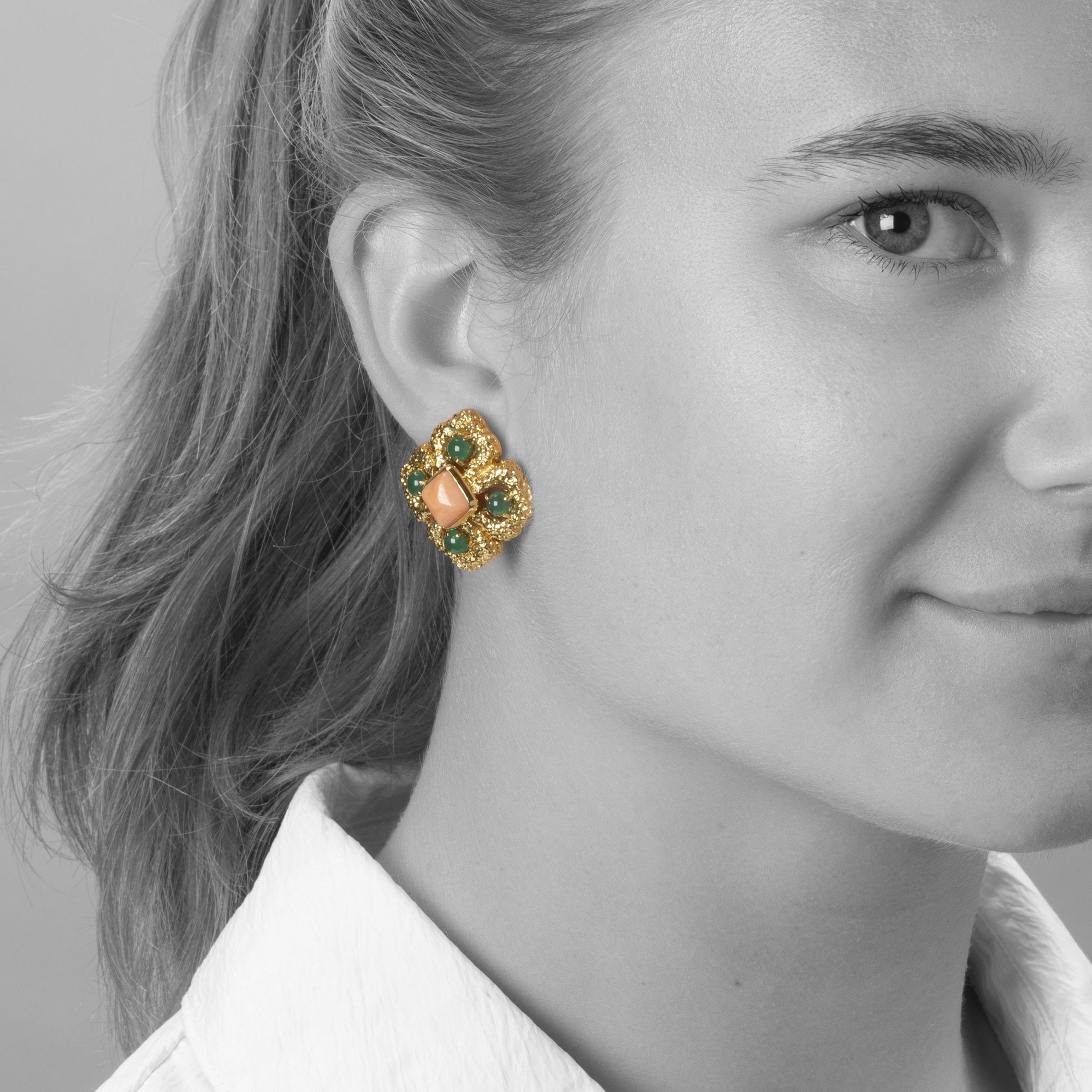 A pair of eighteen carat yellow gold clip earrings, model ‘Delphes’, set with coral and green agate. Signed Van Cleef & Arpels, made in Paris, ca 1970.