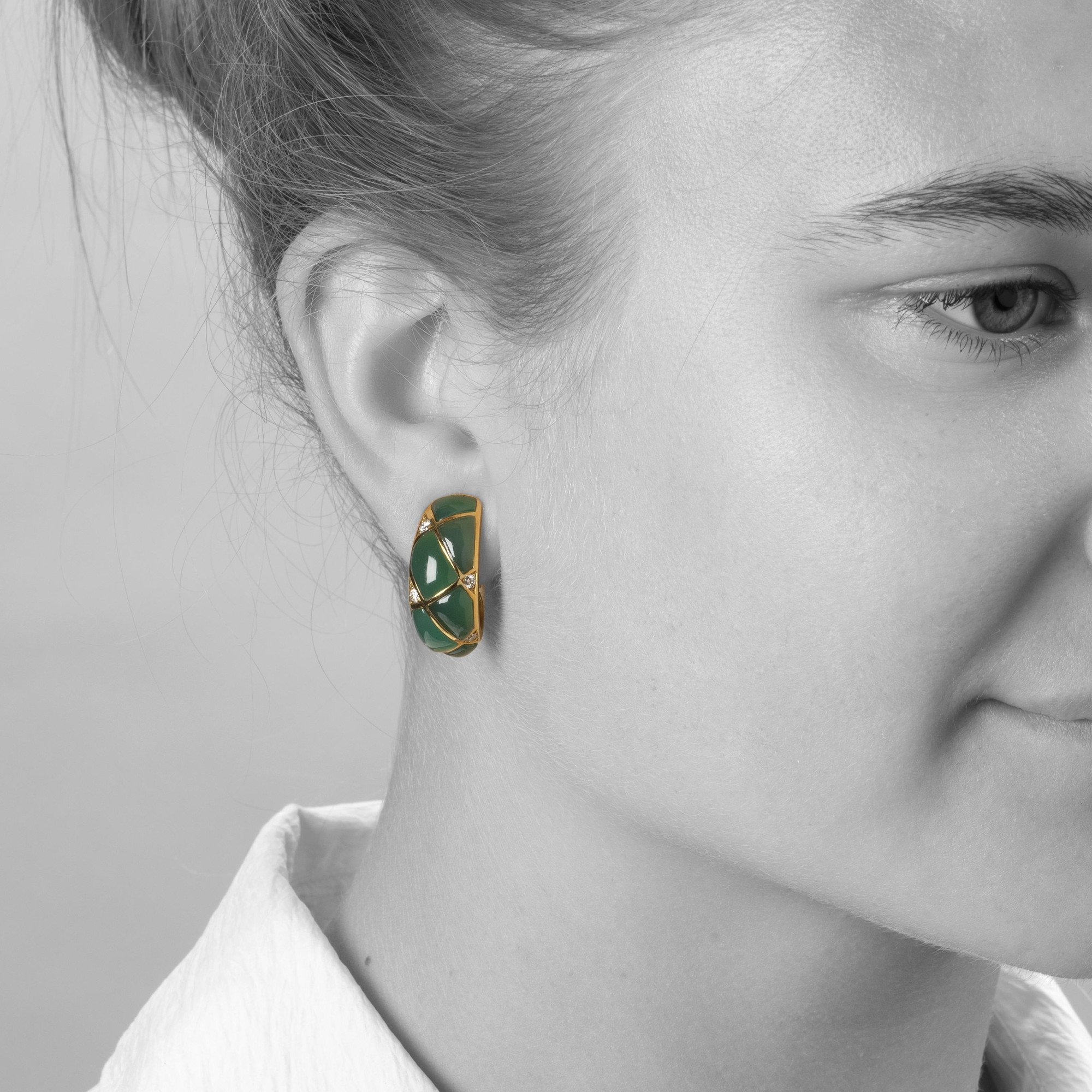 A pair of eighteen carat yellow gold clip earrings, set with green agates and diamonds. Signed Van Cleef & Arpels, dated 1967. Made by Pery et Fils, Paris.