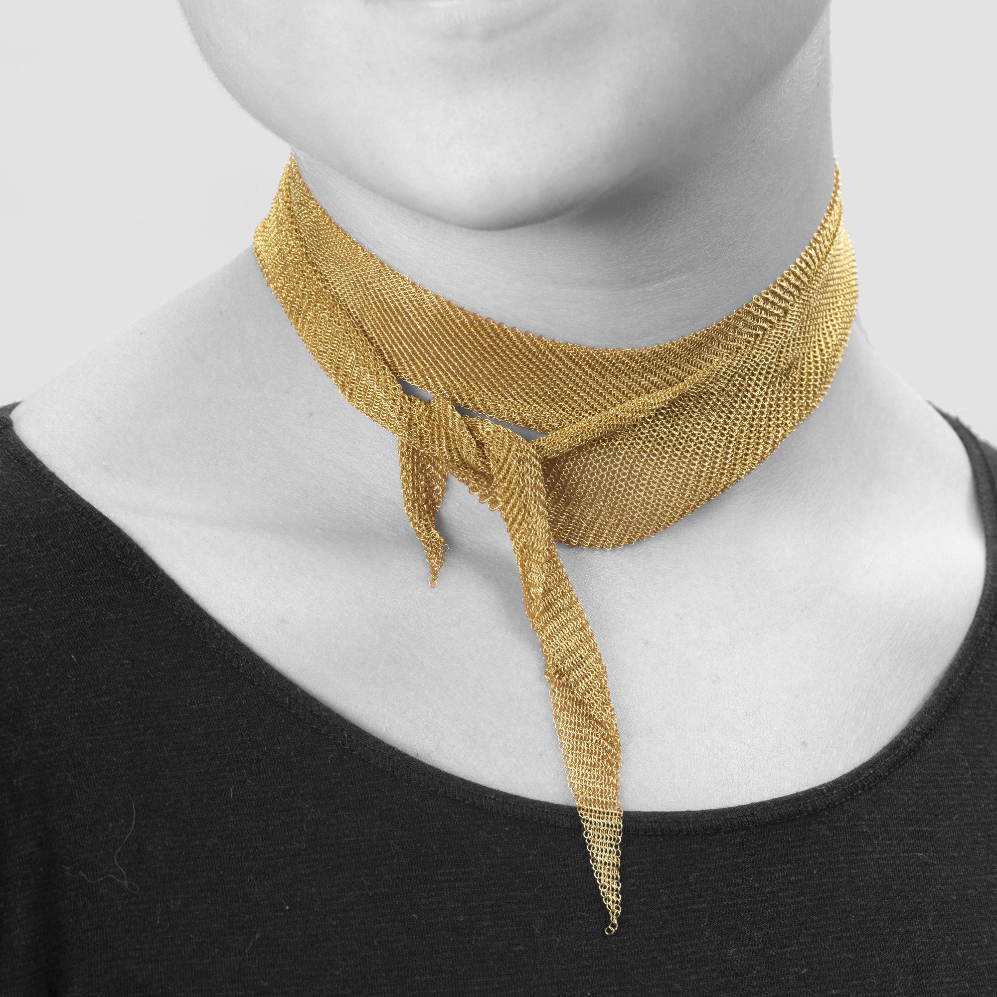 An eighteen carat yellow gold necklace designed as a scarf, signed Elsa Peretti for Tiffany & Co., made in the USA, ca 1980. With original pouch.