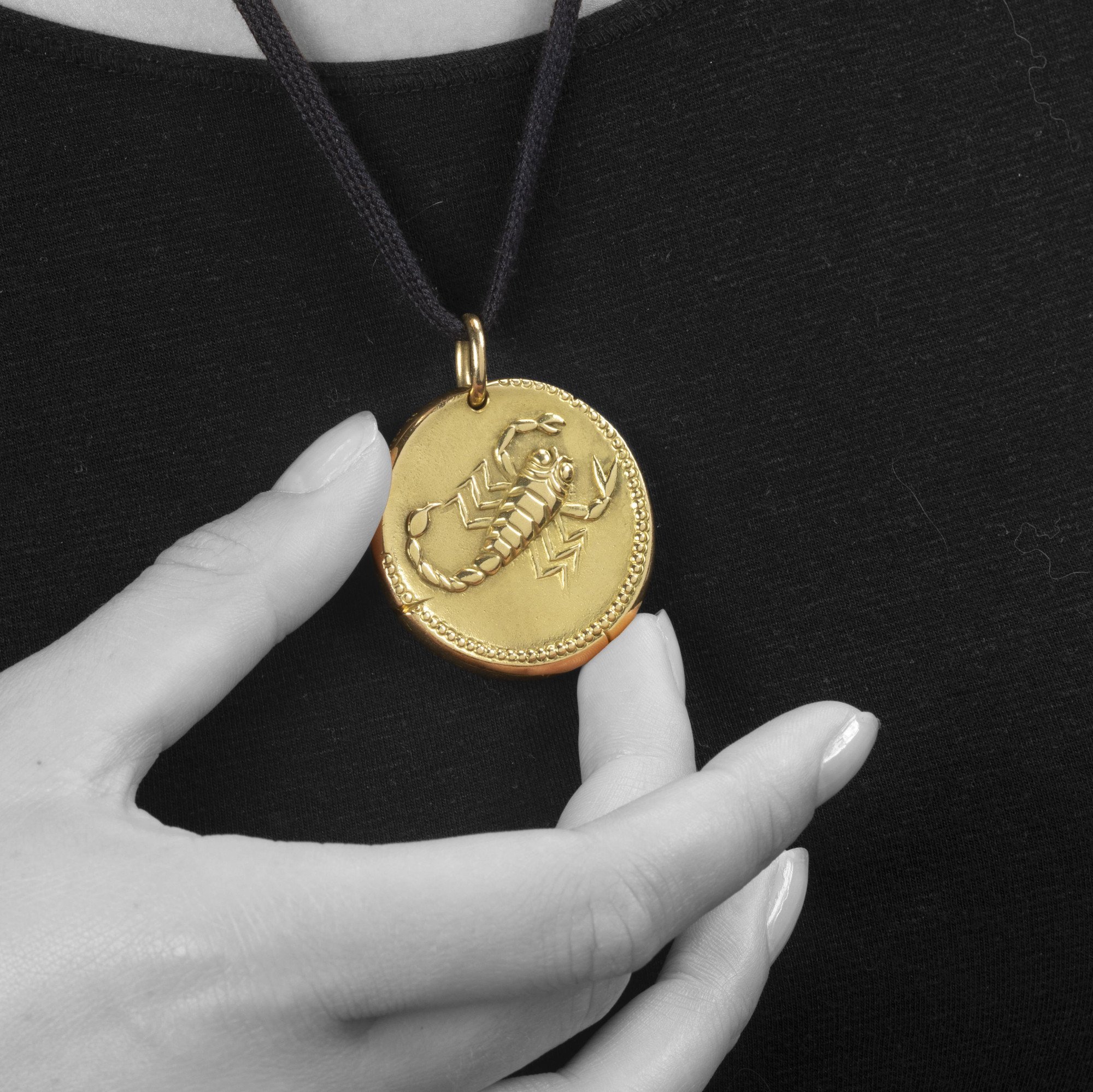 An eighteen carat yellow gold pendant with the zodiac sign scorpio. Signed Van Cleef & Arpels, Paris, ca 1970. With maker’s mark of Georges Lenfant, Paris.